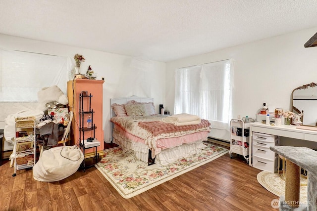 bedroom with wood finished floors and a textured ceiling