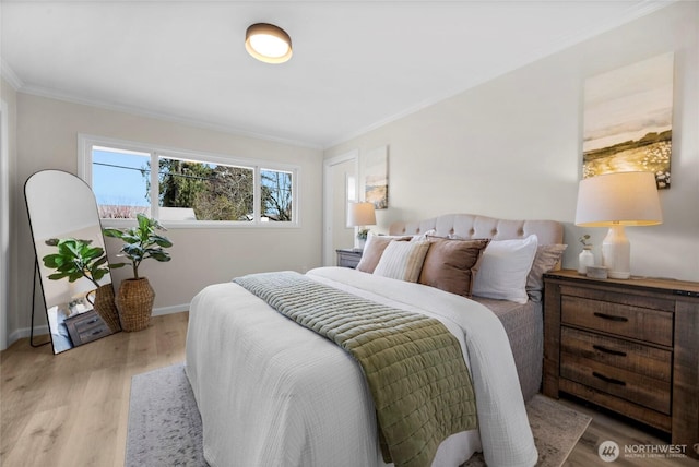 bedroom with crown molding, baseboards, and wood finished floors