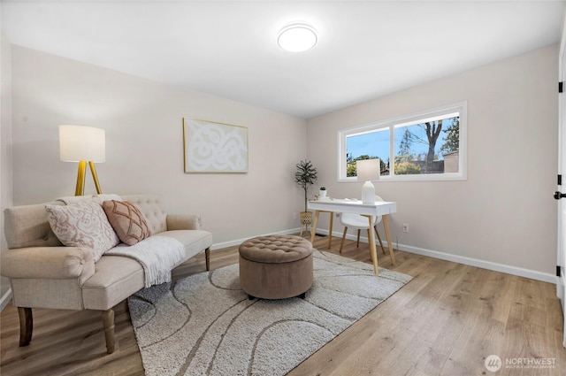 sitting room with wood finished floors and baseboards