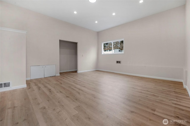 unfurnished room with recessed lighting, baseboards, visible vents, and light wood finished floors