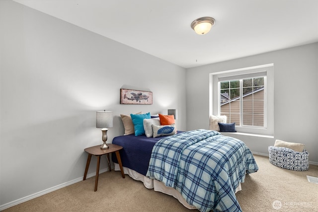 bedroom featuring carpet flooring and baseboards