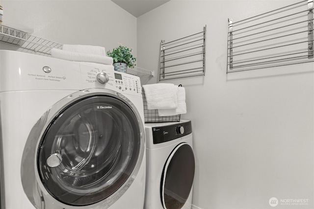 laundry area featuring washing machine and clothes dryer and laundry area