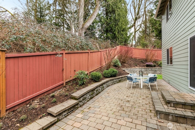 view of patio featuring a fenced backyard and outdoor dining space