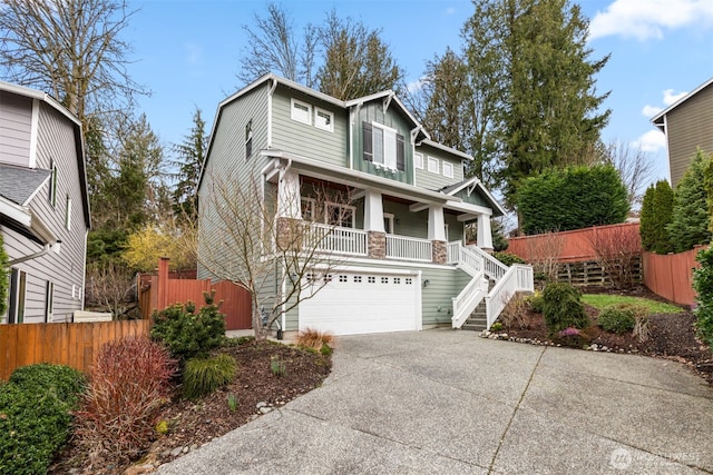 view of front facade featuring driveway, a porch, stairs, and fence