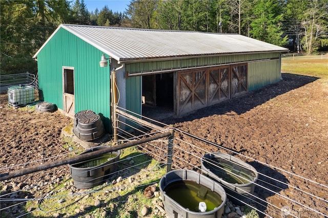 view of outbuilding with central AC unit, an exterior structure, and an outdoor structure