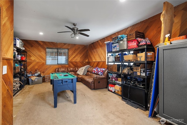 game room with wooden walls, recessed lighting, carpet floors, and ceiling fan