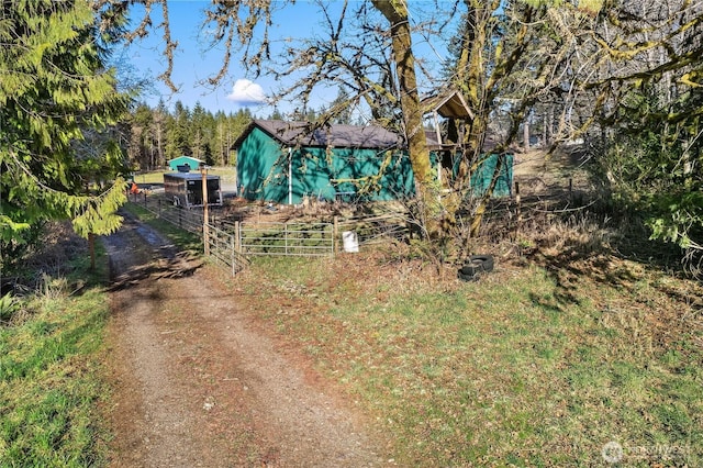 view of yard with fence and driveway