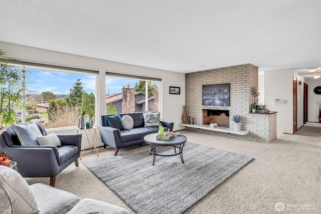 carpeted living area with a brick fireplace and a textured ceiling