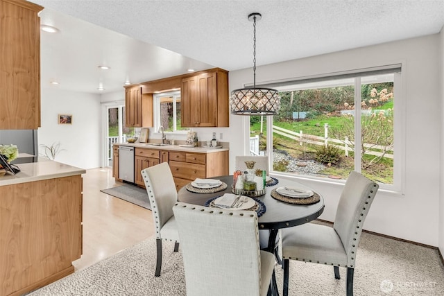 dining room featuring recessed lighting, a textured ceiling, and light wood finished floors