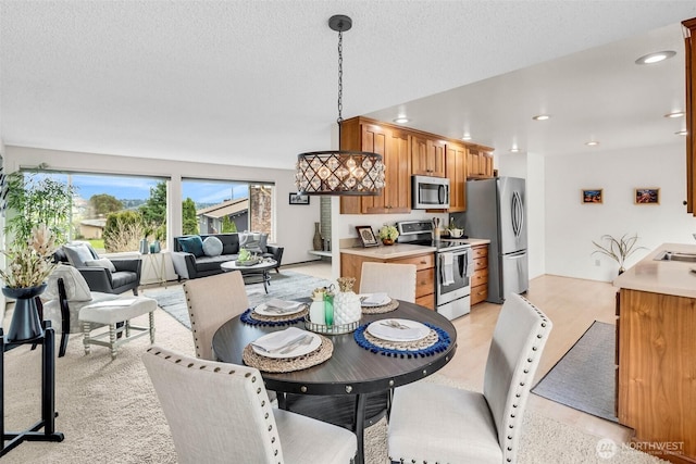 dining area featuring recessed lighting and a textured ceiling