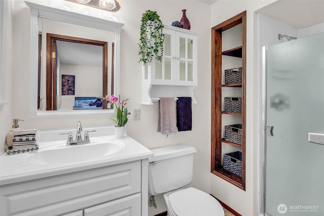 full bathroom featuring vanity, toilet, and a stall shower