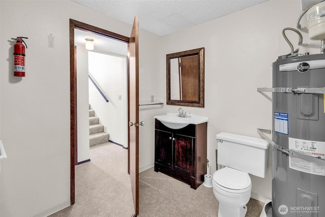 half bath featuring baseboards, strapped water heater, toilet, vanity, and a textured ceiling