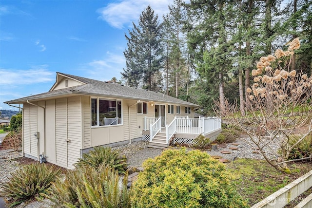 single story home featuring a wooden deck