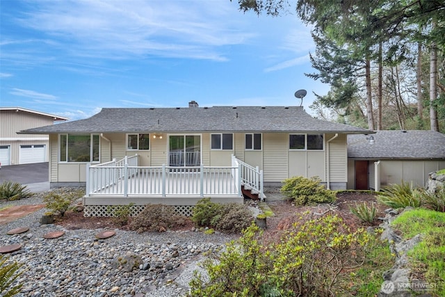 view of front of property with a garage and roof with shingles