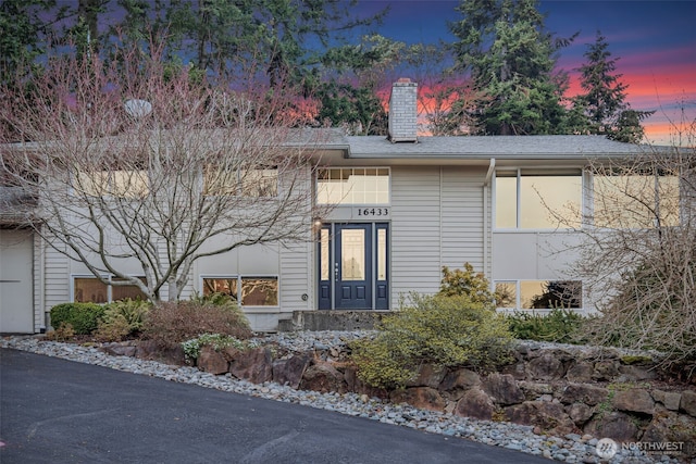 view of front of house featuring a chimney