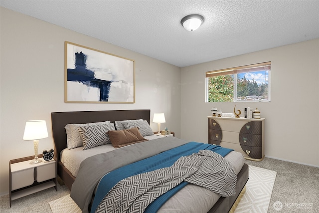 bedroom with baseboards, carpet floors, and a textured ceiling