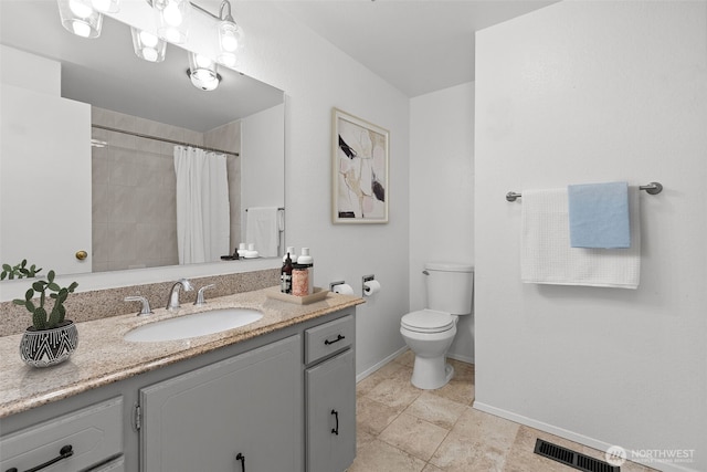 bathroom featuring vanity, baseboards, visible vents, tile patterned flooring, and toilet