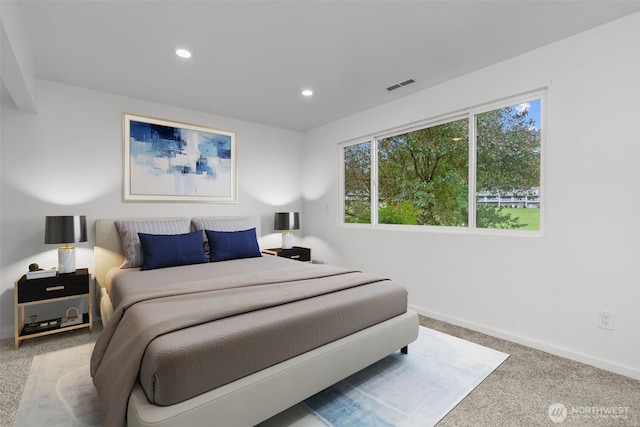 carpeted bedroom with recessed lighting, visible vents, and baseboards