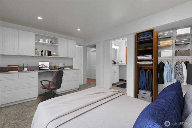 bedroom featuring recessed lighting, carpet, and built in study area