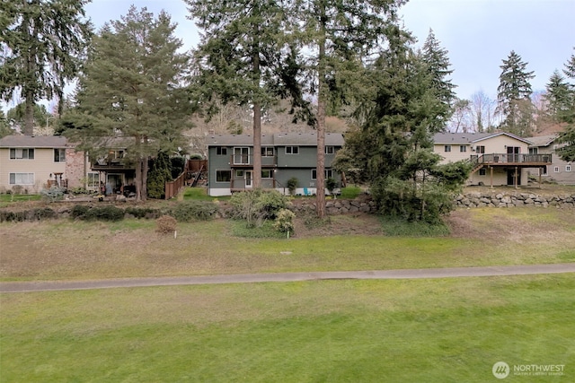 view of home's community with a yard, a residential view, and stairway