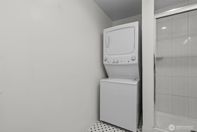 laundry area with laundry area and stacked washer / dryer