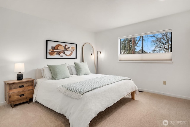 bedroom featuring light carpet and baseboards