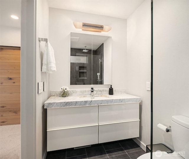 bathroom with tile patterned flooring, toilet, and vanity