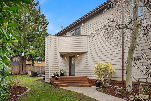 exterior space featuring a front yard and fence