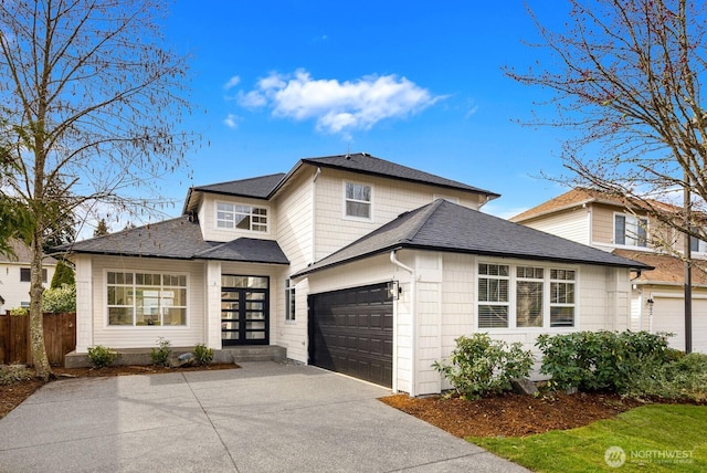 view of front of property with fence, a garage, driveway, and a shingled roof