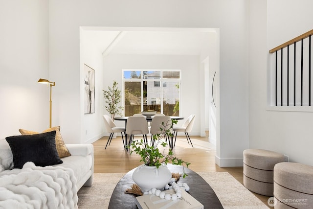 living room featuring baseboards and light wood finished floors