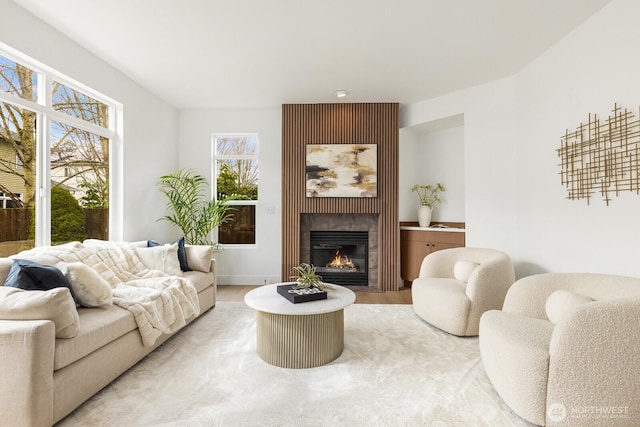 living room with a large fireplace and light wood-style flooring