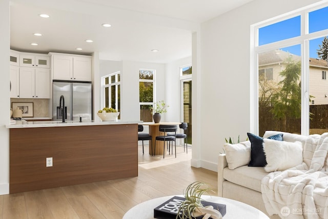 living room with recessed lighting and light wood-style flooring