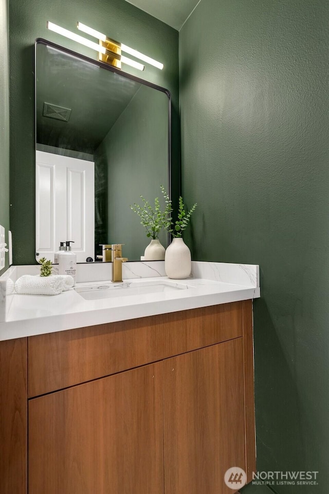 bathroom with vanity and visible vents