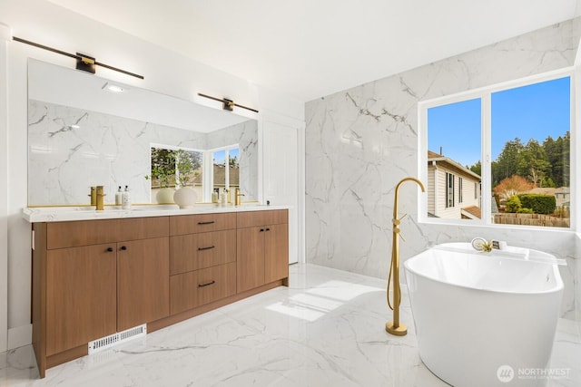 full bathroom with stone wall, visible vents, marble finish floor, and a sink