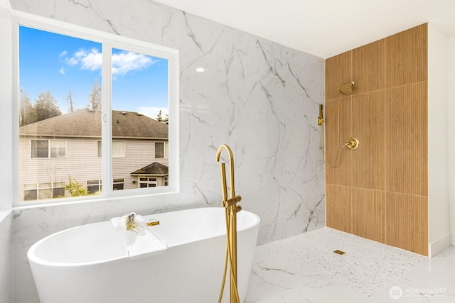 full bath featuring marble finish floor, stone wall, and tile walls