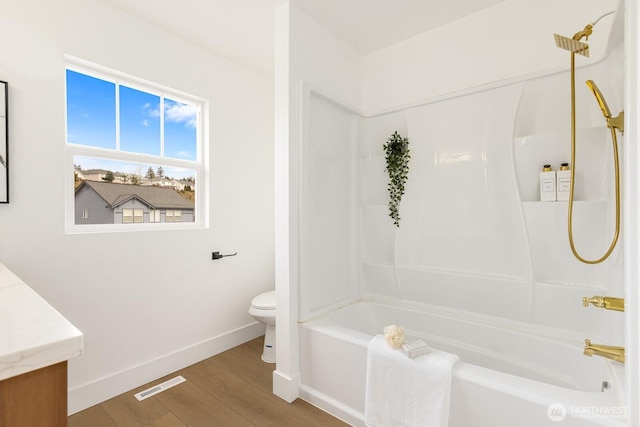 full bathroom with visible vents, toilet, wood finished floors, and washtub / shower combination