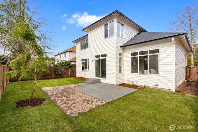 back of property with a patio area, a yard, and a fenced backyard