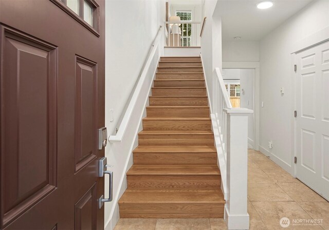 interior space with tile patterned flooring, recessed lighting, baseboards, and a wealth of natural light