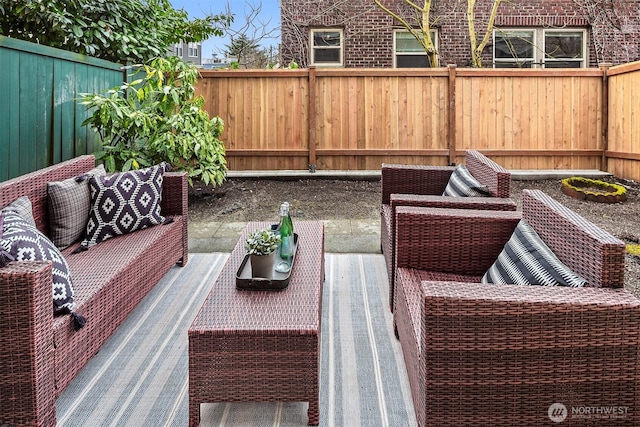 deck with outdoor lounge area and a fenced backyard