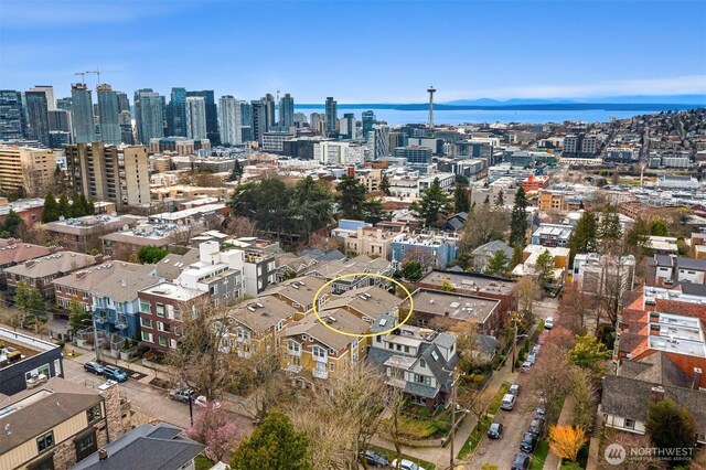 birds eye view of property featuring a view of city and a water view