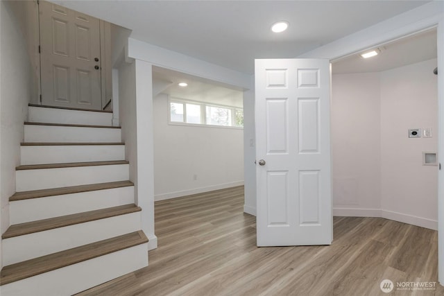 interior space featuring recessed lighting, wood finished floors, and baseboards