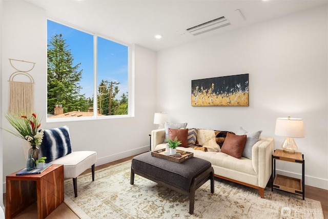 living room featuring visible vents, recessed lighting, baseboards, and wood finished floors