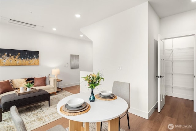 dining area with visible vents, recessed lighting, wood finished floors, and baseboards