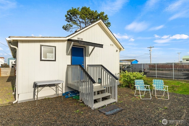 rear view of property with fence