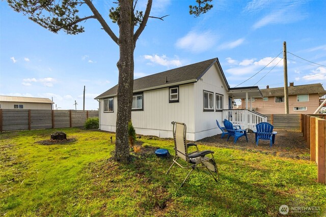 exterior space with a lawn, a fire pit, and a fenced backyard