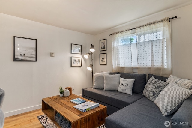 living room featuring baseboards and light wood-style floors