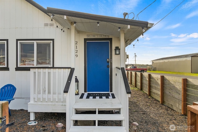 doorway to property with fence