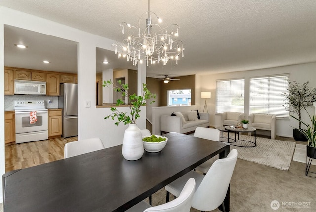 dining space featuring recessed lighting, a textured ceiling, light wood-style flooring, and a ceiling fan