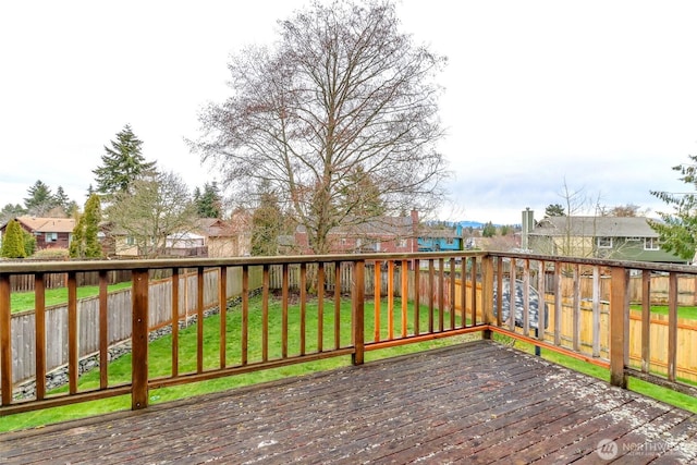 wooden deck with a yard, a residential view, and a fenced backyard