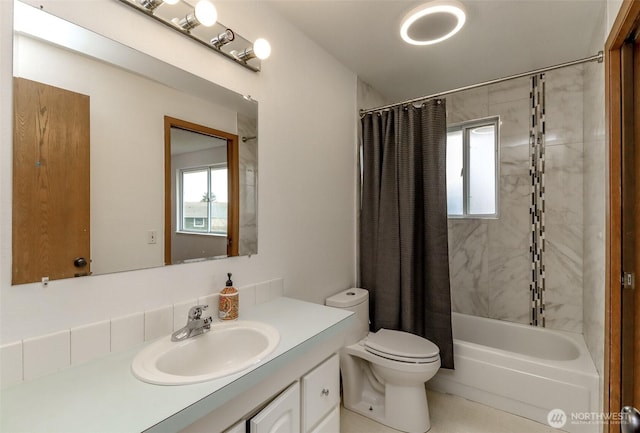 bathroom with shower / bathtub combination with curtain, toilet, a healthy amount of sunlight, and vanity